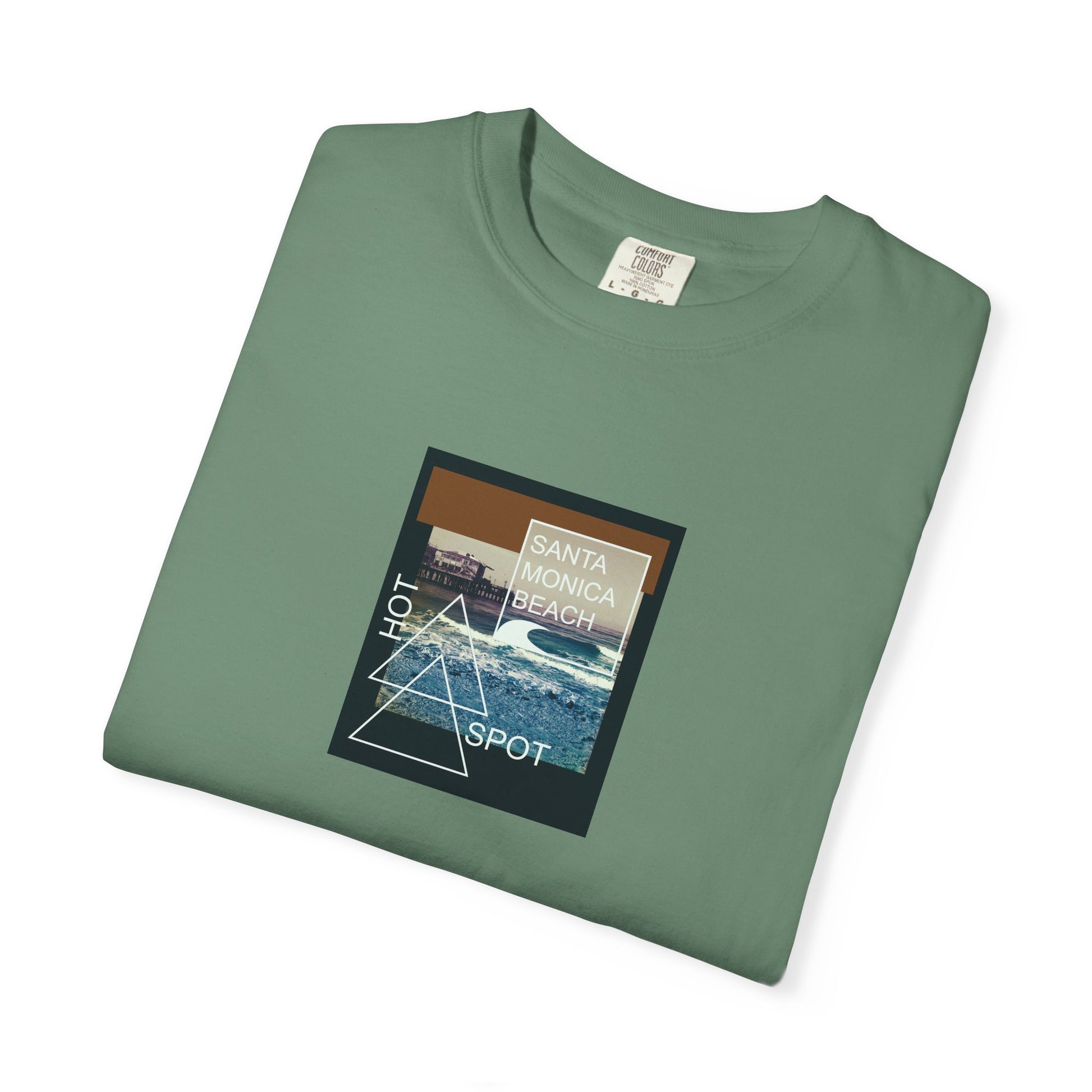 Folded green t-shirt with a graphic design on a white background
