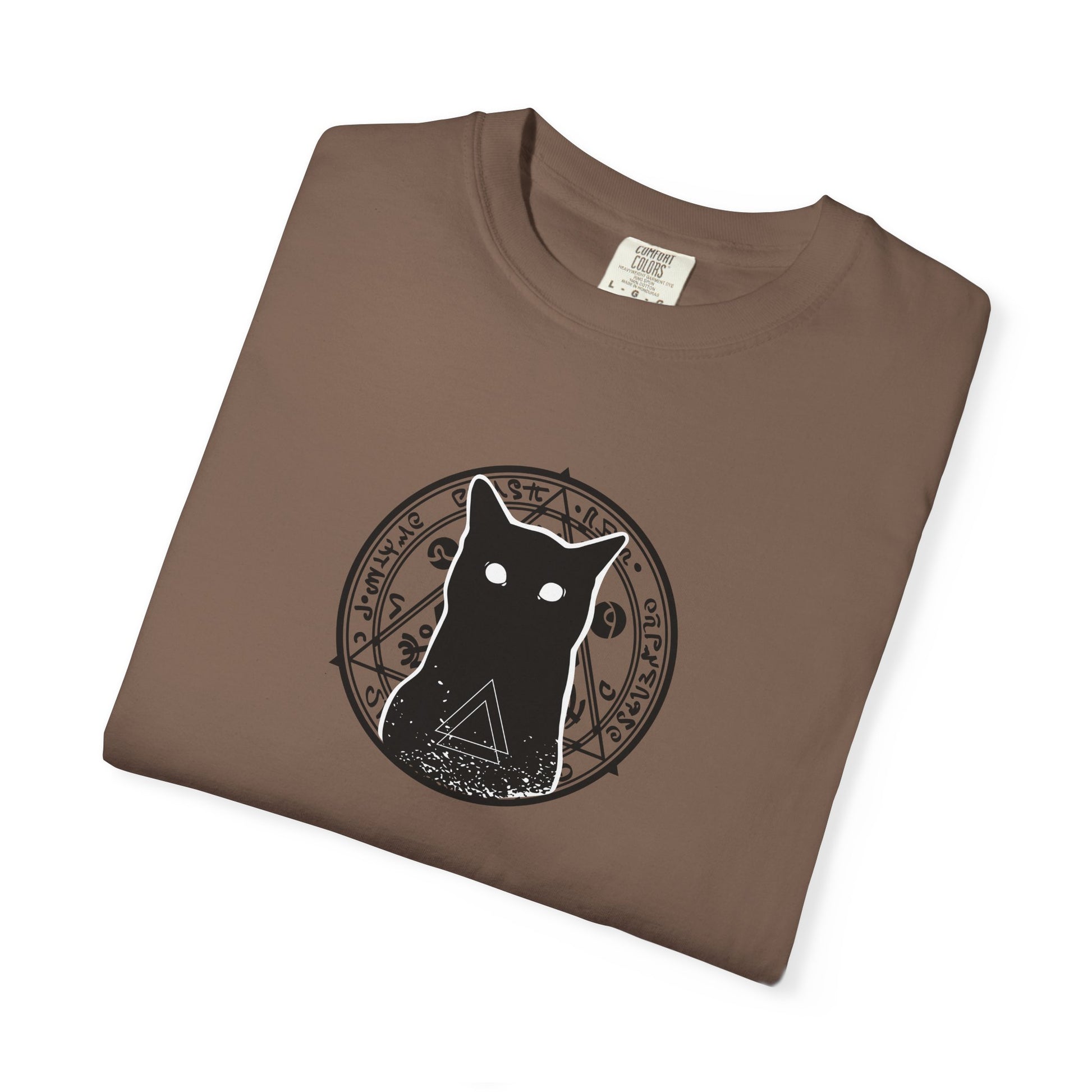 A brown folded crewneck t-shirt featuring a black graphic of a cat inside a circular occult-style symbol, displayed on a clean white background.