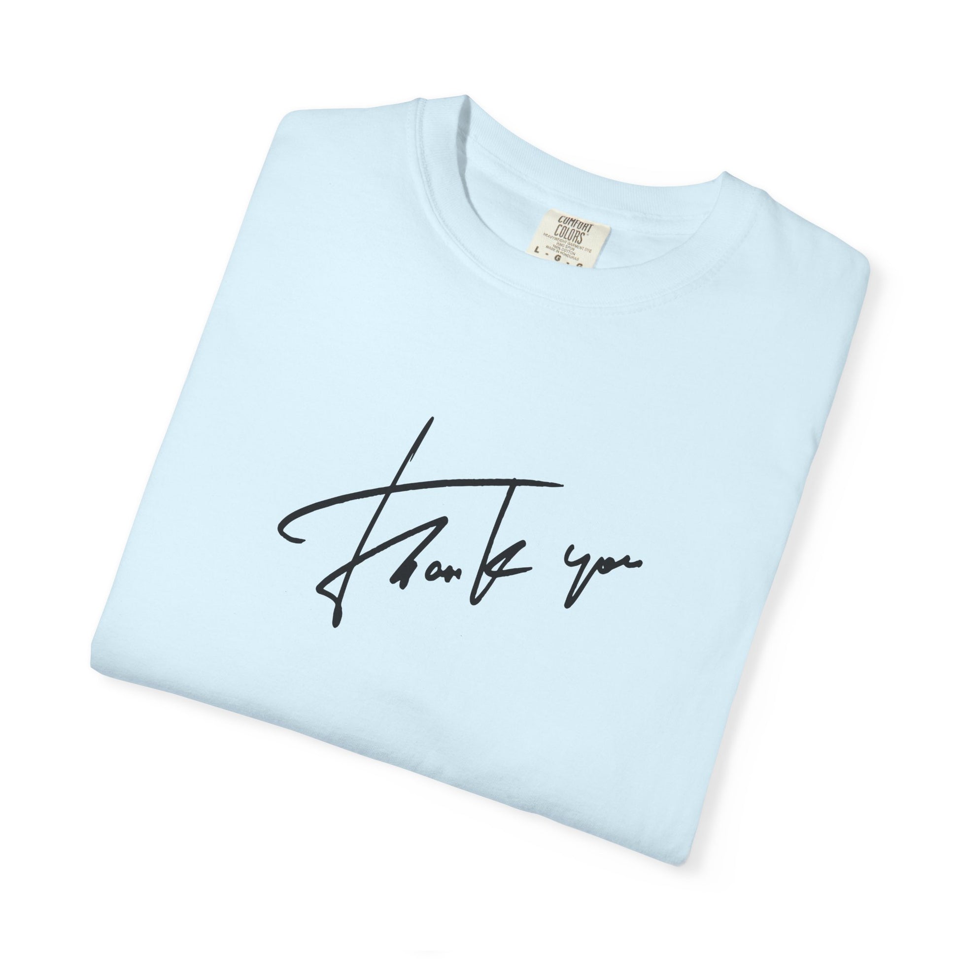 A light blue folded crewneck t-shirt with a black cursive 'Thank you' script printed on the front, displayed on a clean white background.