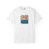 A white short-sleeve crewneck t-shirt featuring a square graphic print on the chest with a stylized orange and yellow sun over blue ocean waves, surrounded by text.