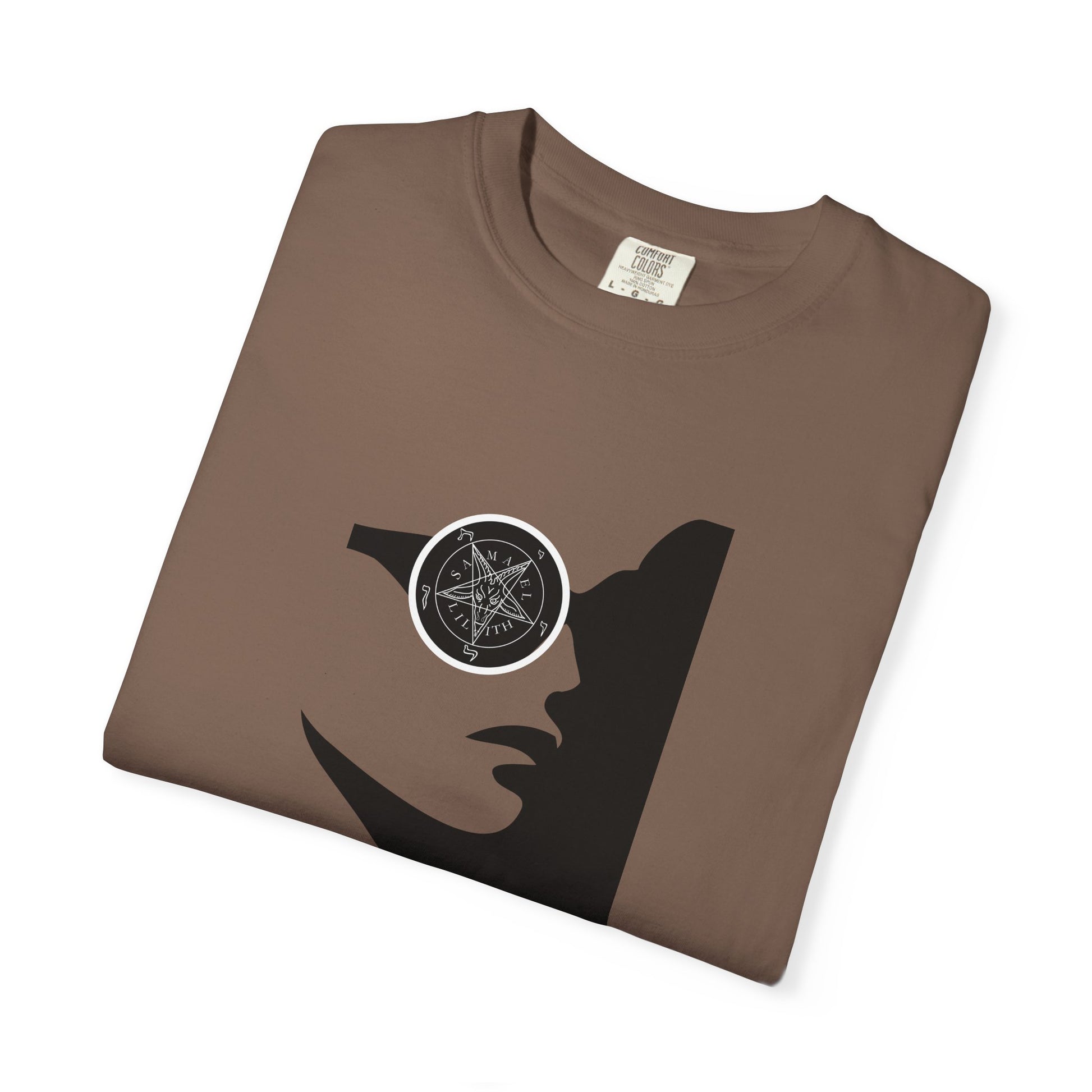 A folded brown t-shirt with a black silhouette graphic of a woman's profile wearing a circular eyepatch with a pentagram design, shown on a white background.