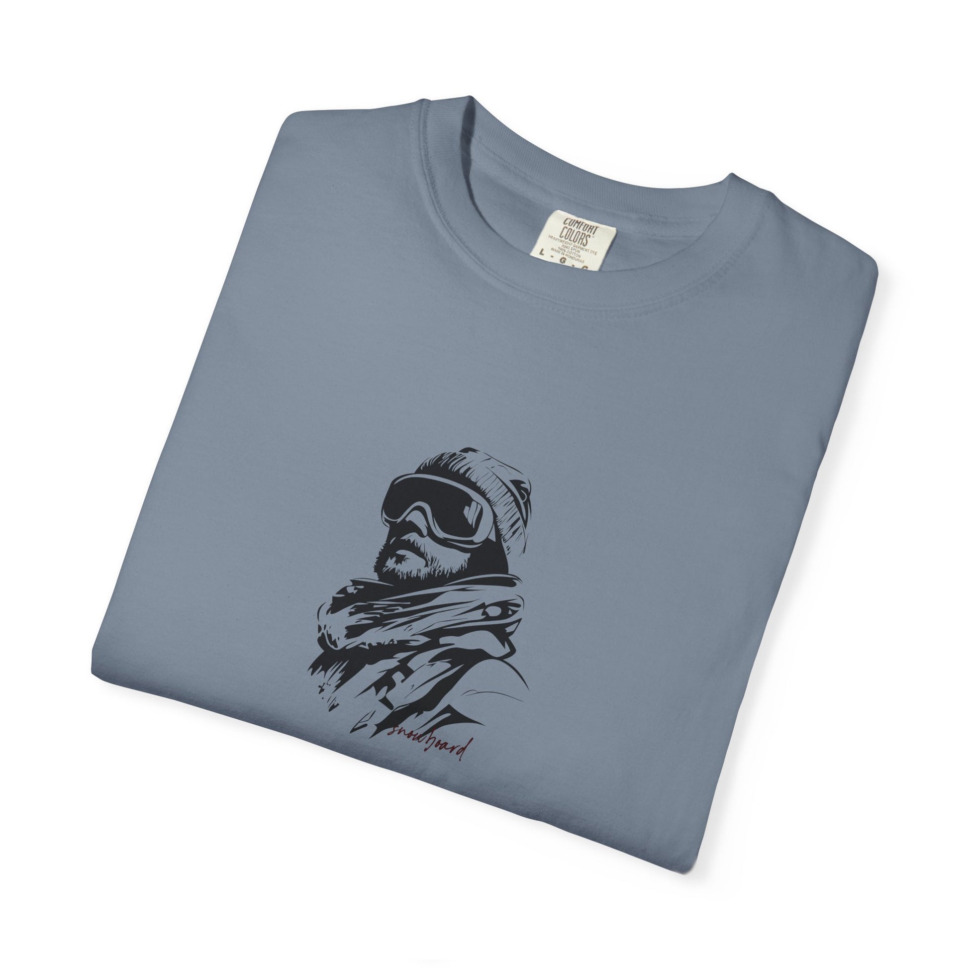 Folded blue t-shirt with a graphic of a person wearing a beanie and goggles on a white background