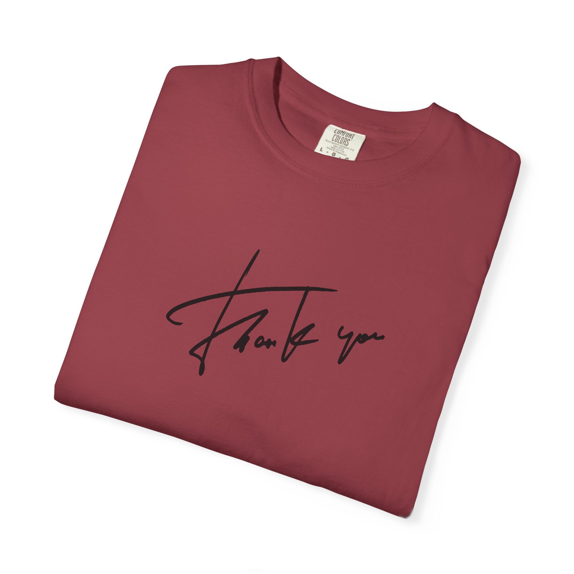 Folded red t-shirt with a thanks graphic 