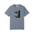 A slate blue short-sleeve crewneck t-shirt featuring a black graphic of a woman's profile with a pentagram symbol in her eye, displayed on a clean white background.