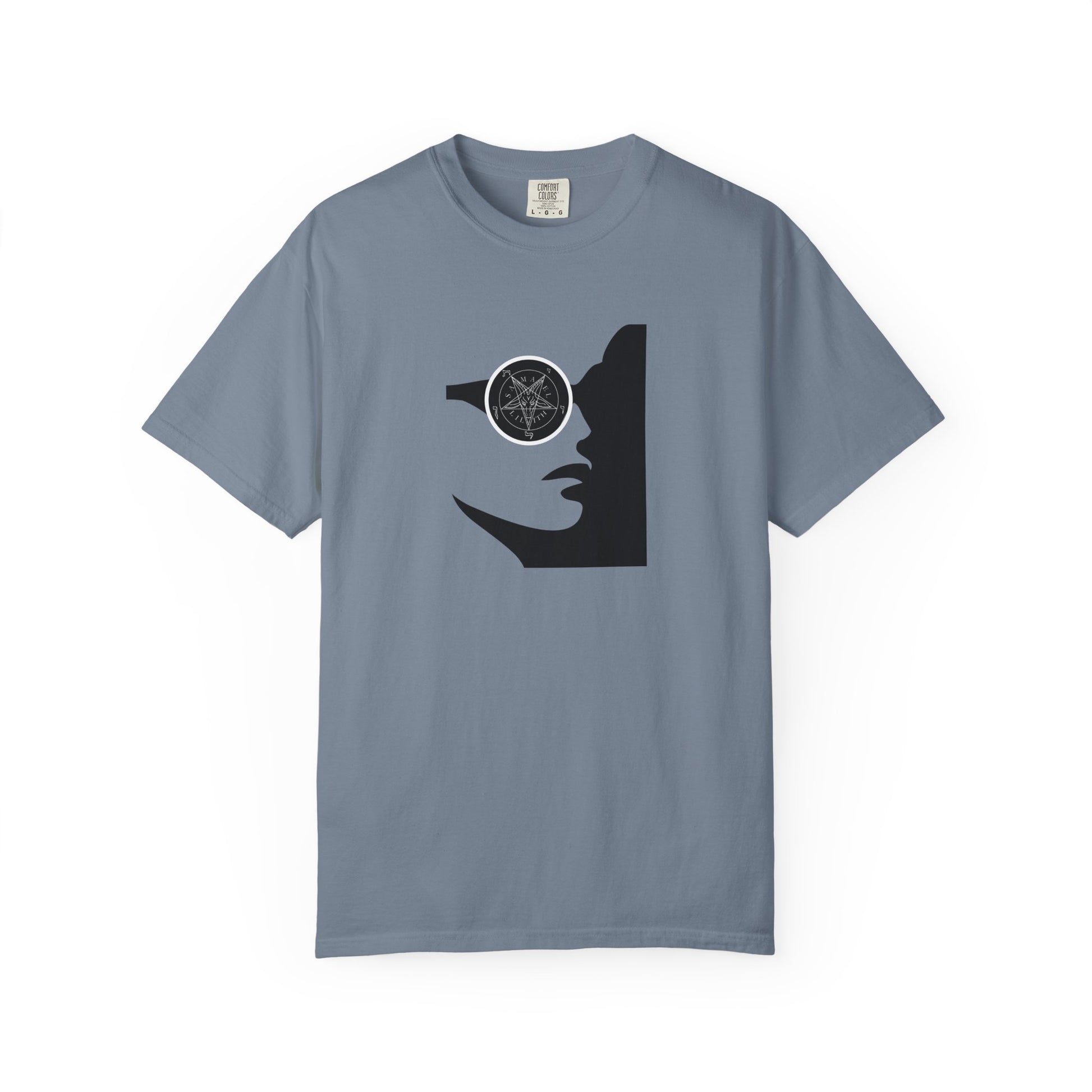 A slate blue short-sleeve crewneck t-shirt featuring a black graphic of a woman's profile with a pentagram symbol in her eye, displayed on a clean white background.