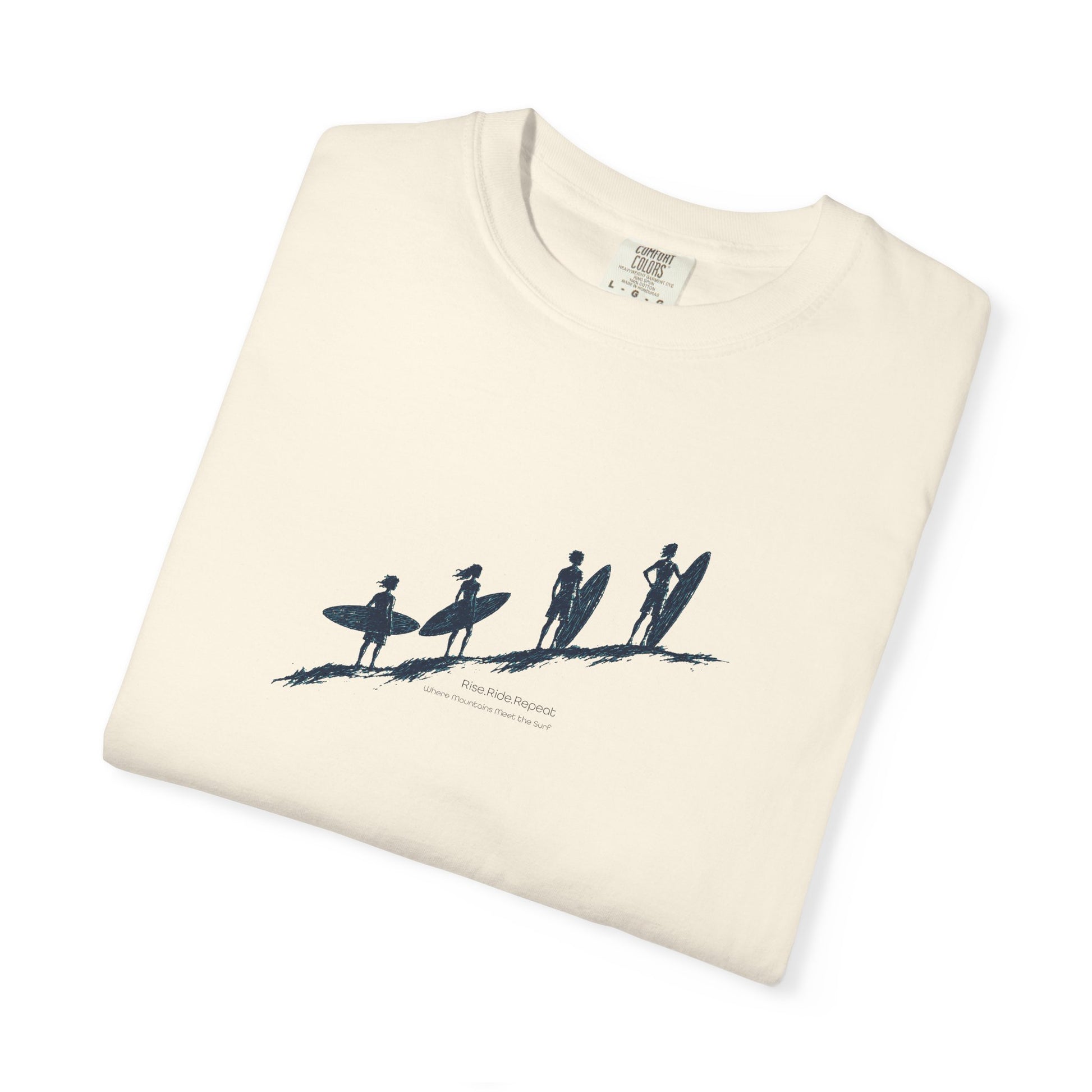 An off-white folded crewneck t-shirt with a dark blue graphic of four surfers on a beach and the text 'Hawaii Surfing' printed underneath.