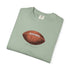 Folded green t-shirt with a brown football graphic on a white background