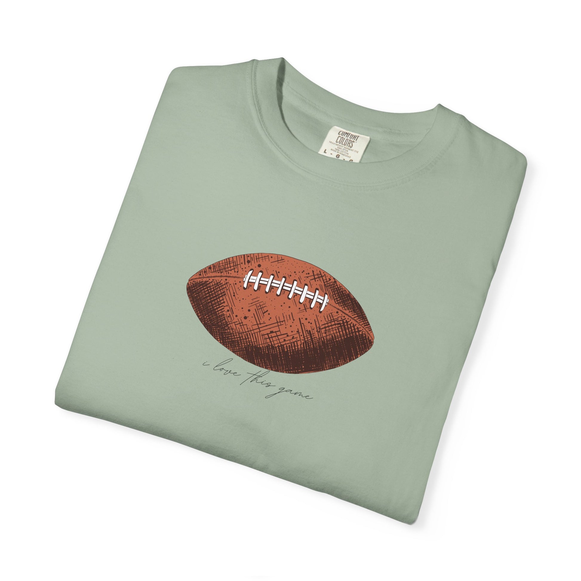 Folded green t-shirt with a brown football graphic on a white background