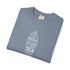 Folded green t-shirt with a dalmatian print and colorful bow design on a white background