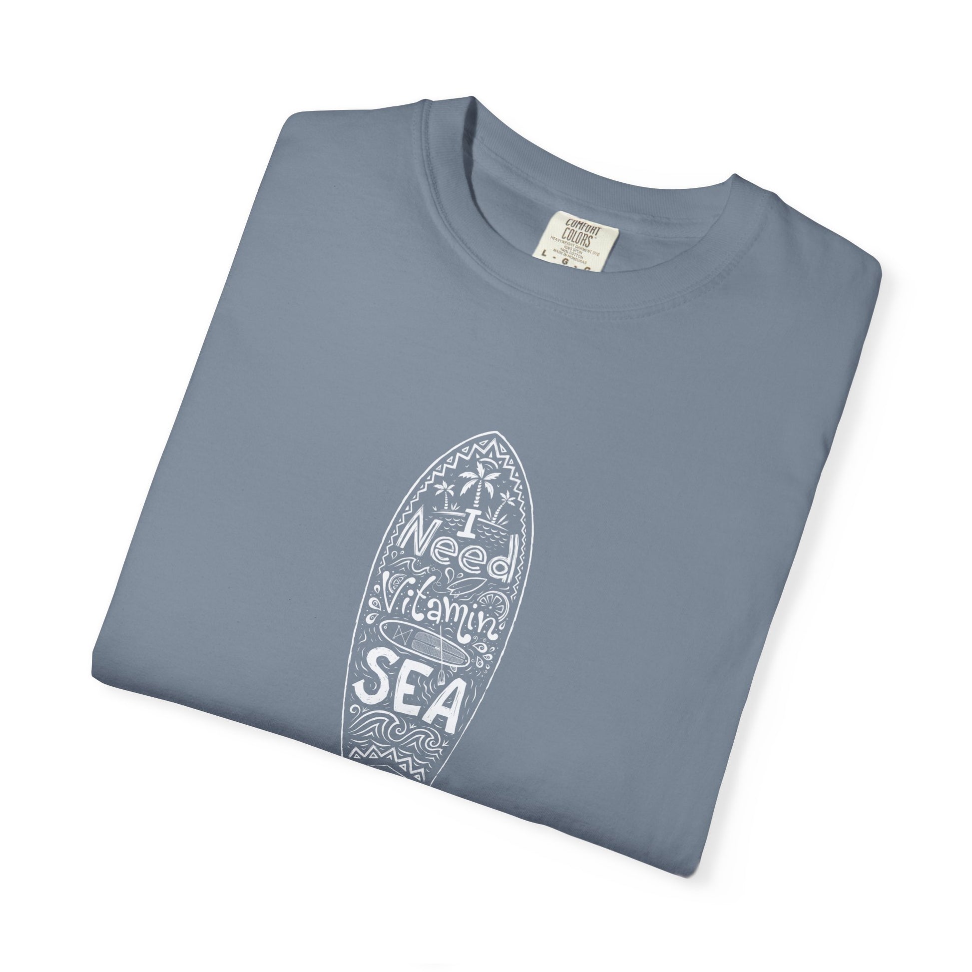 Folded green t-shirt with a dalmatian print and colorful bow design on a white background