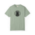 A sage green short-sleeve crewneck t-shirt featuring a black circular graphic of a cat with a triangle below it on the chest, displayed against a plain white background.