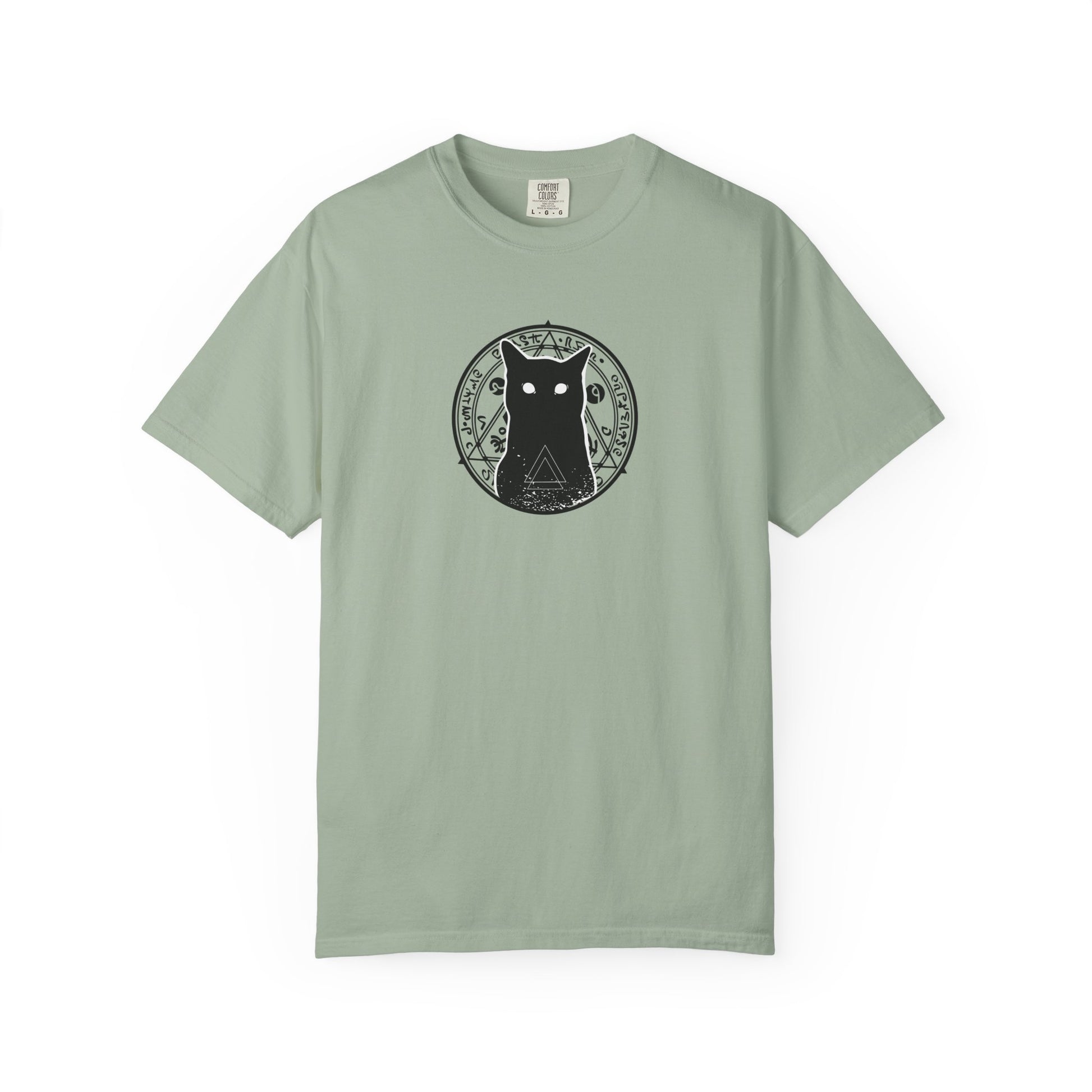 A sage green short-sleeve crewneck t-shirt featuring a black circular graphic of a cat with a triangle below it on the chest, displayed against a plain white background.