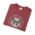 A folded maroon crewneck t-shirt featuring a circular graphic print with a blue and brown butterfly, astrological symbols, and the text 'MACHADO' and 'D. PEDRO MACHADO'.