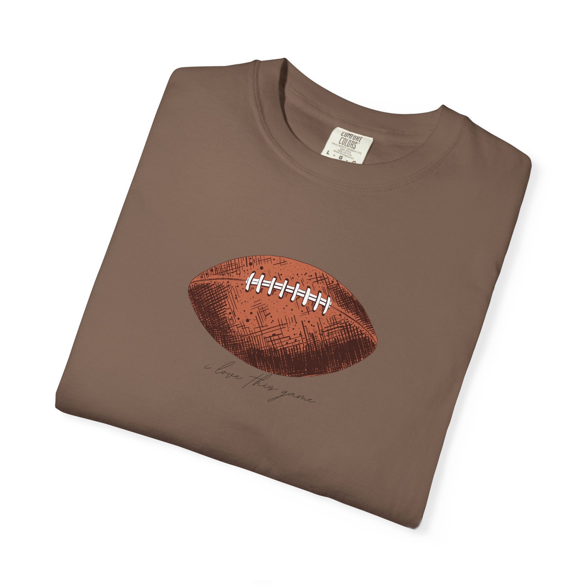Folded brown t-shirt with a football graphic on a white background