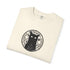 A folded cream-colored t-shirt with a black circular graphic of a cat inside a mystical symbol on the chest, displayed on a clean white background.