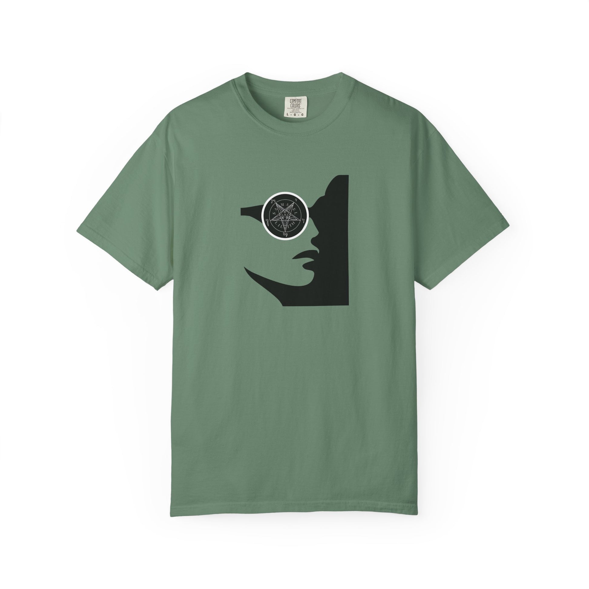 A sage green short-sleeve crewneck t-shirt featuring a black graphic of a woman's profile with a pentagram symbol in her eye, displayed on a clean white background.
