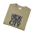 Folded khaki t-shirt with 'New York City' text on a white background