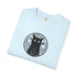 A light blue folded crewneck t-shirt featuring a black graphic of a cat inside a circular occult-style design with the word 'Wiccan' printed around it.