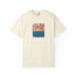 An off-white short-sleeve crewneck t-shirt featuring a central graphic of a sunset over blue ocean waves, with text reading 'I'D LIKE TO LEARN MORE ABOUT SUNSET' and 'SUNSET I'D LIKE TO LEARN MORE ABOUT'.