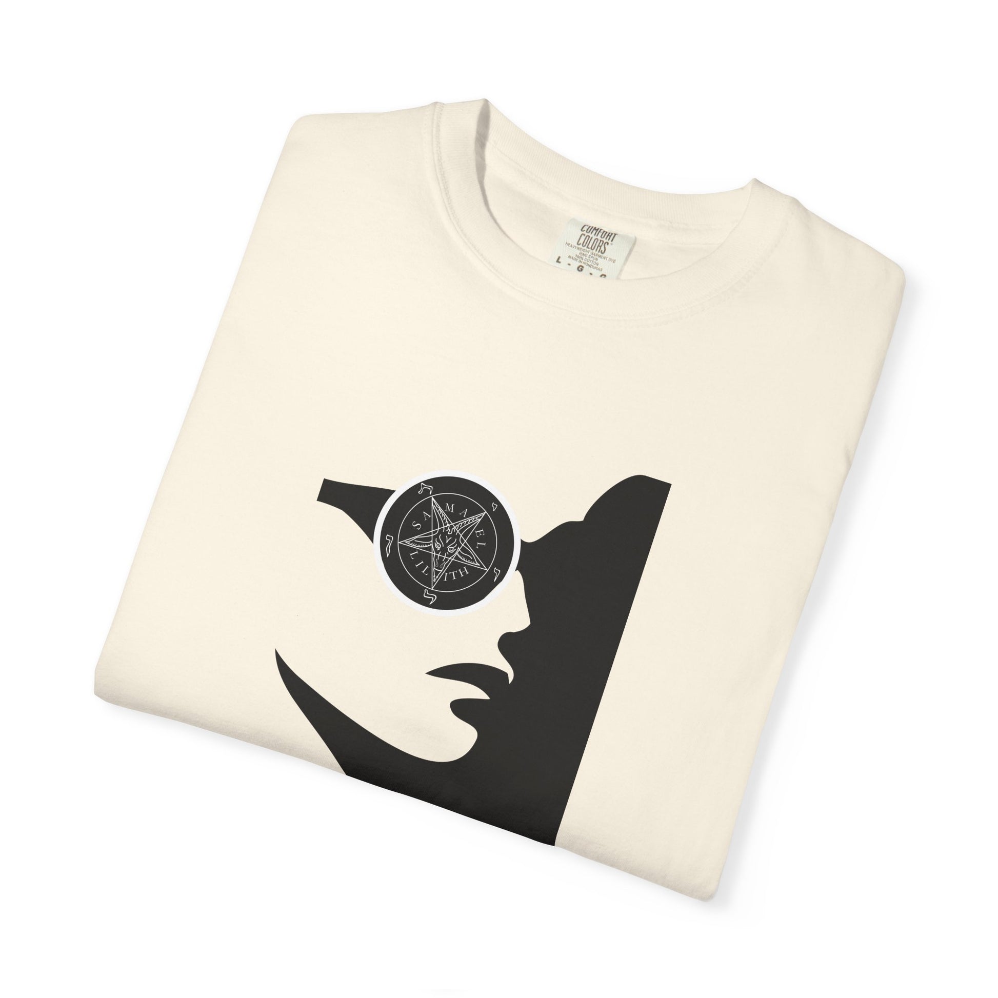 An off-white folded crewneck t-shirt featuring a black graphic print of a stylized face wearing a circular eyepatch with a pentagram design.