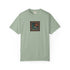 A sage green short-sleeve crewneck t-shirt with a square graphic print on the chest depicting a stylized blue wave and orange sun over a patterned border, shown on a plain white background.
