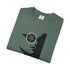 A folded dark green t-shirt with a black silhouette of a woman's profile wearing a circular eyepatch with a pentagram design, shown on a white background.
