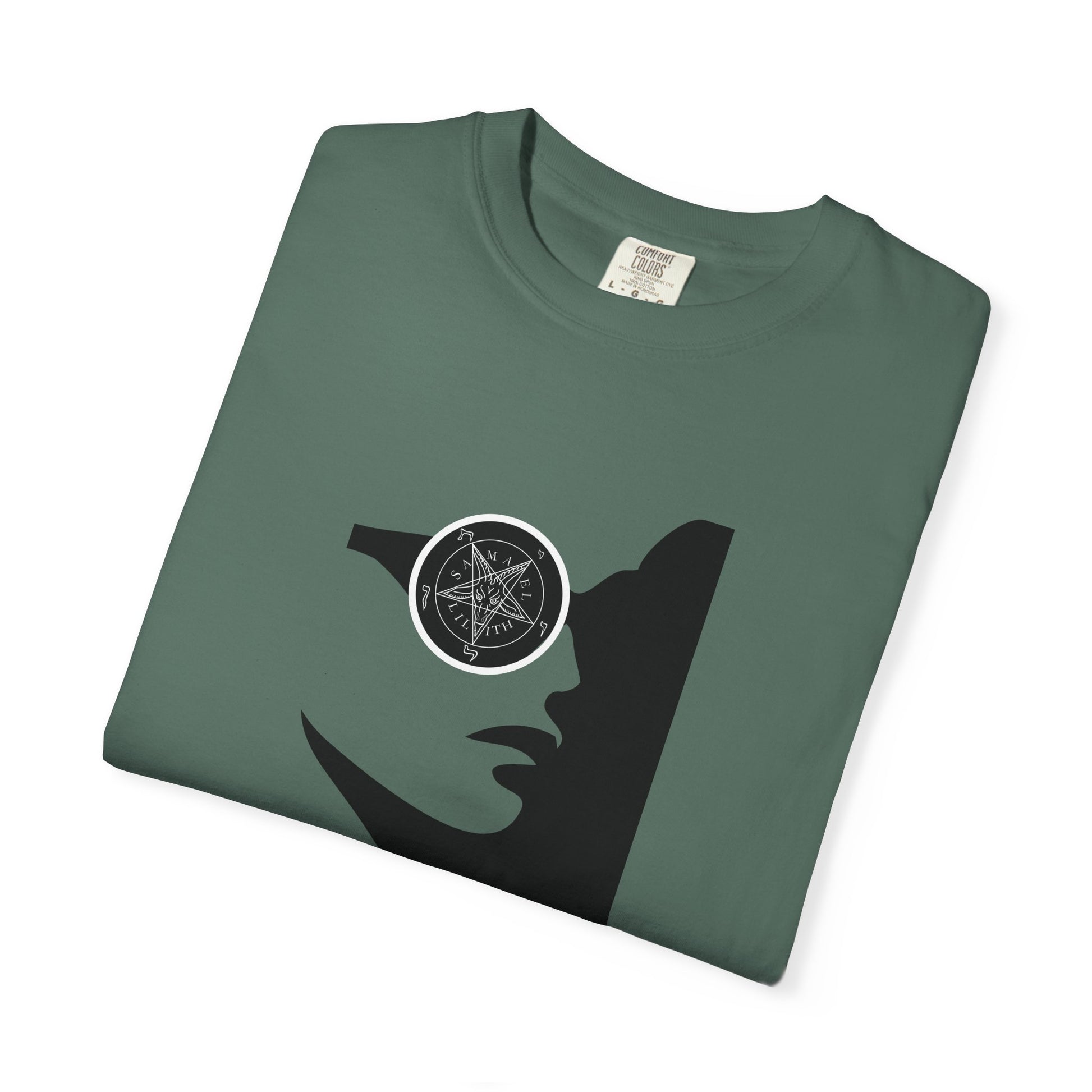 A folded dark green t-shirt with a black silhouette of a woman's profile wearing a circular eyepatch with a pentagram design, shown on a white background.