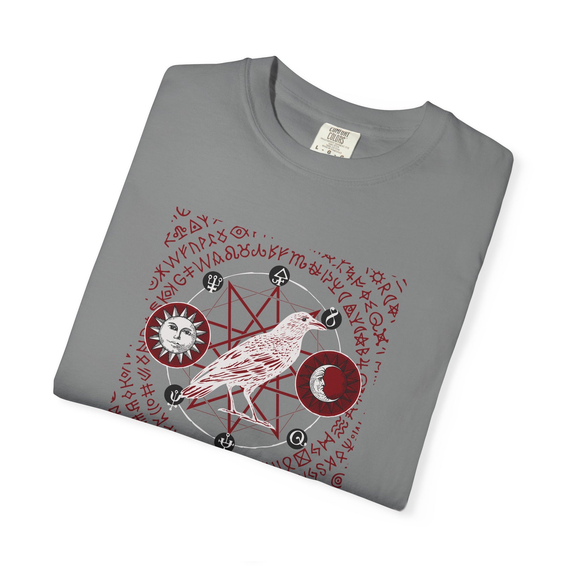 A folded gray crewneck t-shirt featuring a detailed occult-style graphic print with a bird, pentagram, moon phases, and red runic text on a white background.