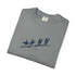 A folded gray crewneck t-shirt with a blue graphic print of surfers on a beach, displayed on a clean white background.