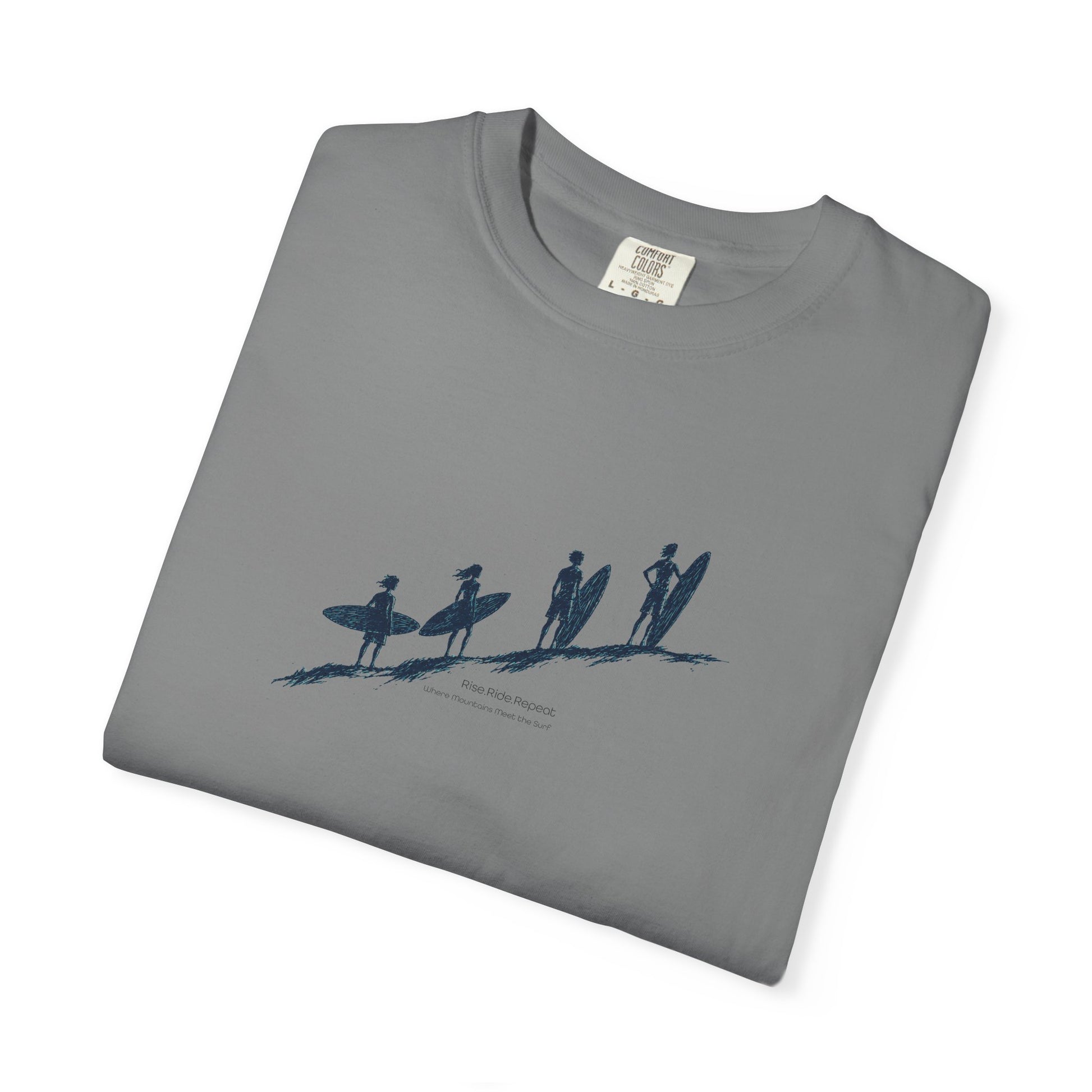 A folded gray crewneck t-shirt with a blue graphic print of surfers on a beach, displayed on a clean white background.
