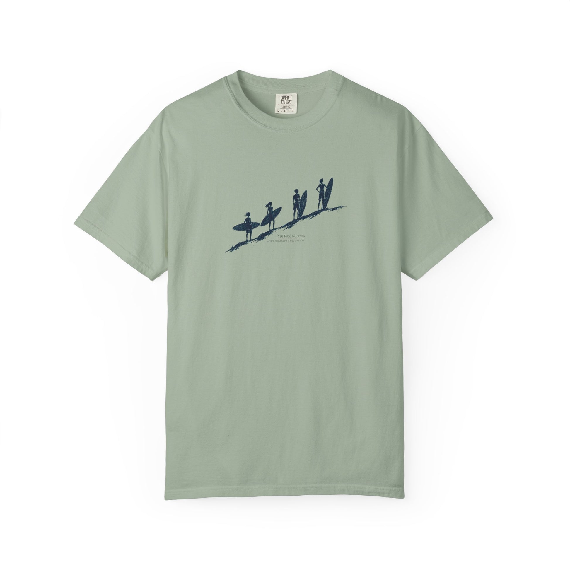 A sage green short-sleeve crewneck t-shirt featuring a dark navy blue graphic of surfers on a beach across the chest, displayed on a clean white background.