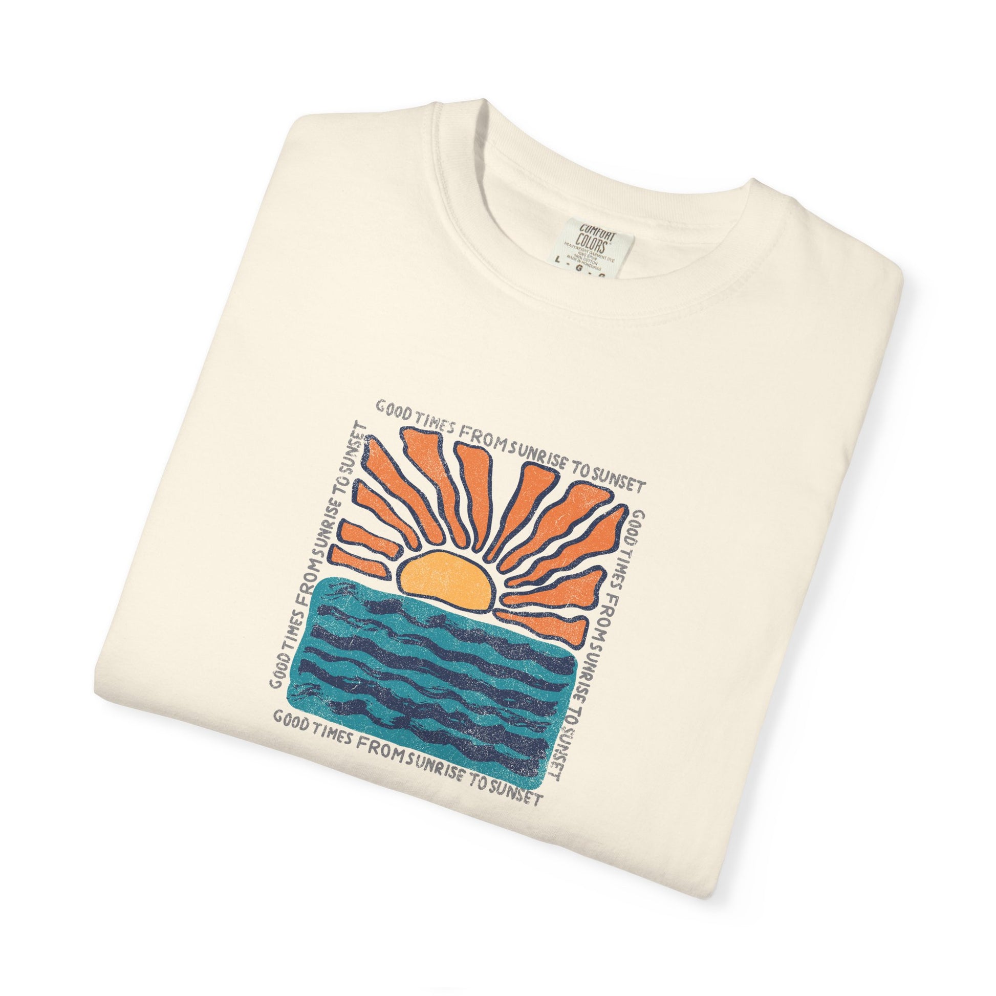 An off-white folded crewneck t-shirt featuring a colorful graphic print of a rising sun over blue waves, with the text 'GOOD TIMES FROM SUNRISE TO SUNSET' printed around the design.