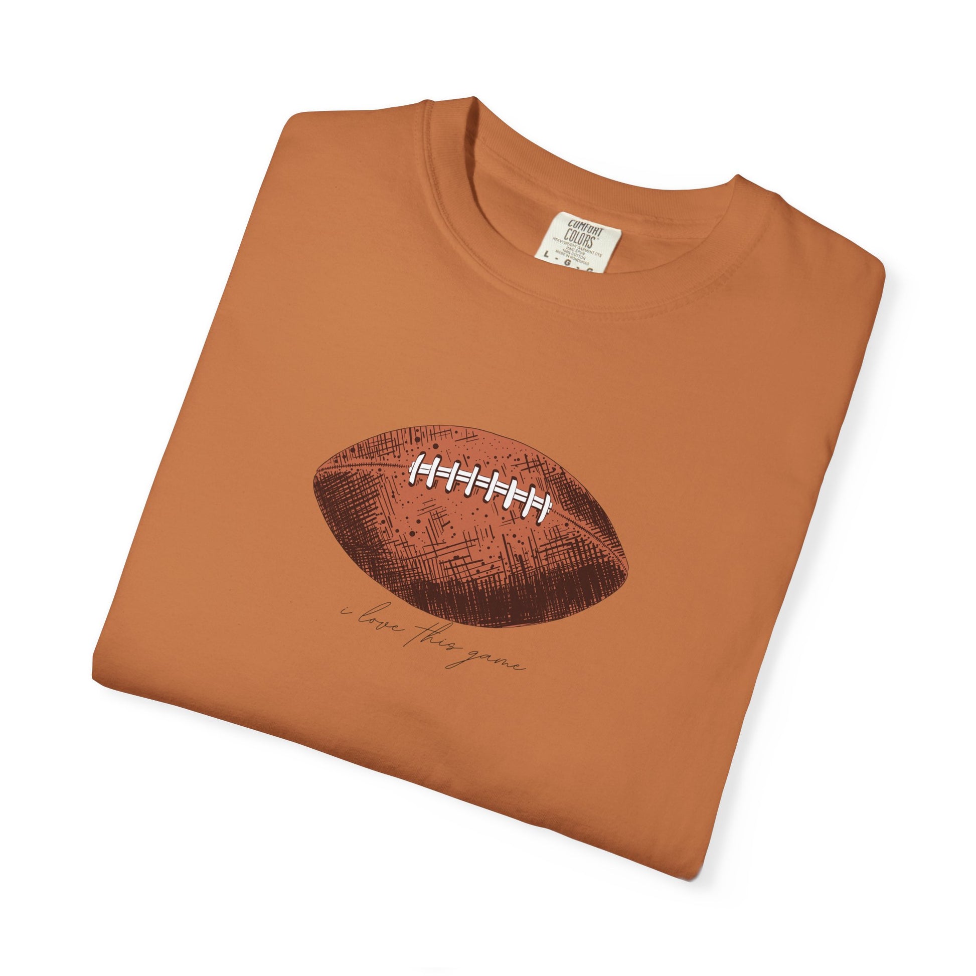 Folded brown t-shirt with football graphic and text on a white background
