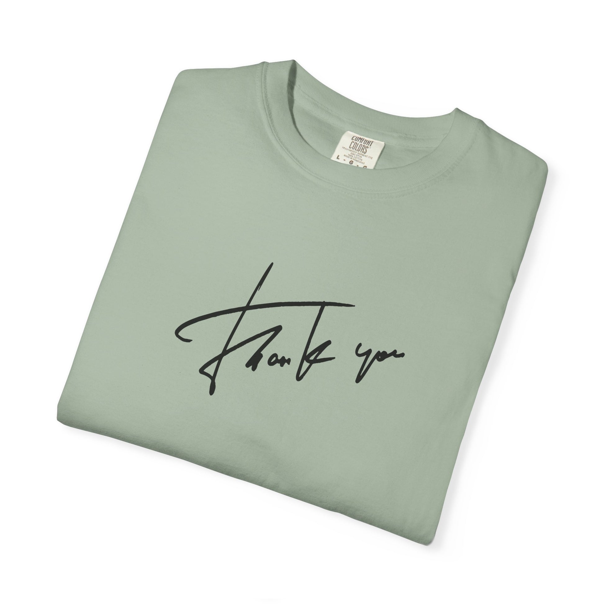 Folded green t-shirt with a thanks graphic 