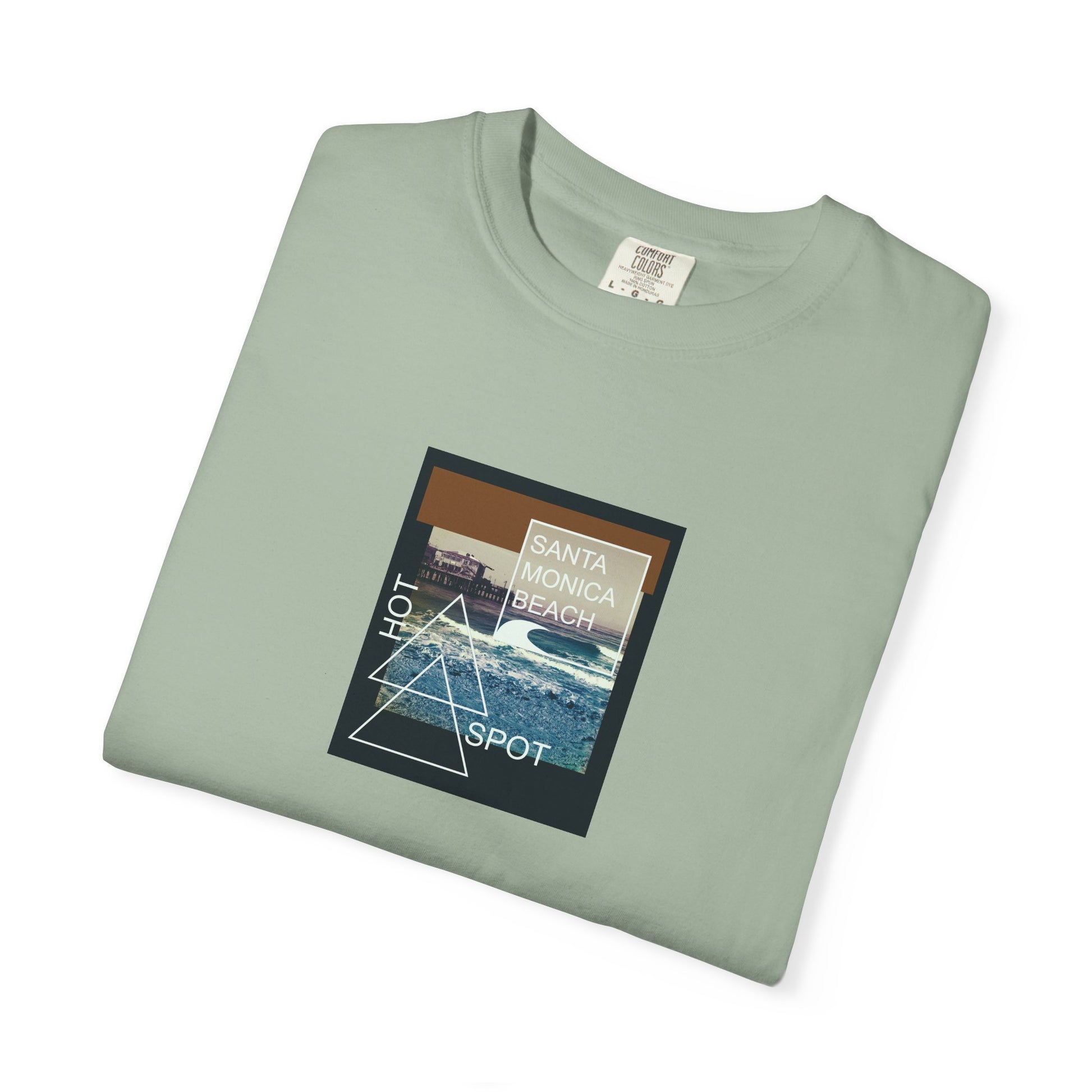 Folded green t-shirt with a graphic design on a white background