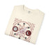 An off-white folded crewneck t-shirt featuring a detailed occult-style graphic print with a bird, moon phases, stars, and runes.