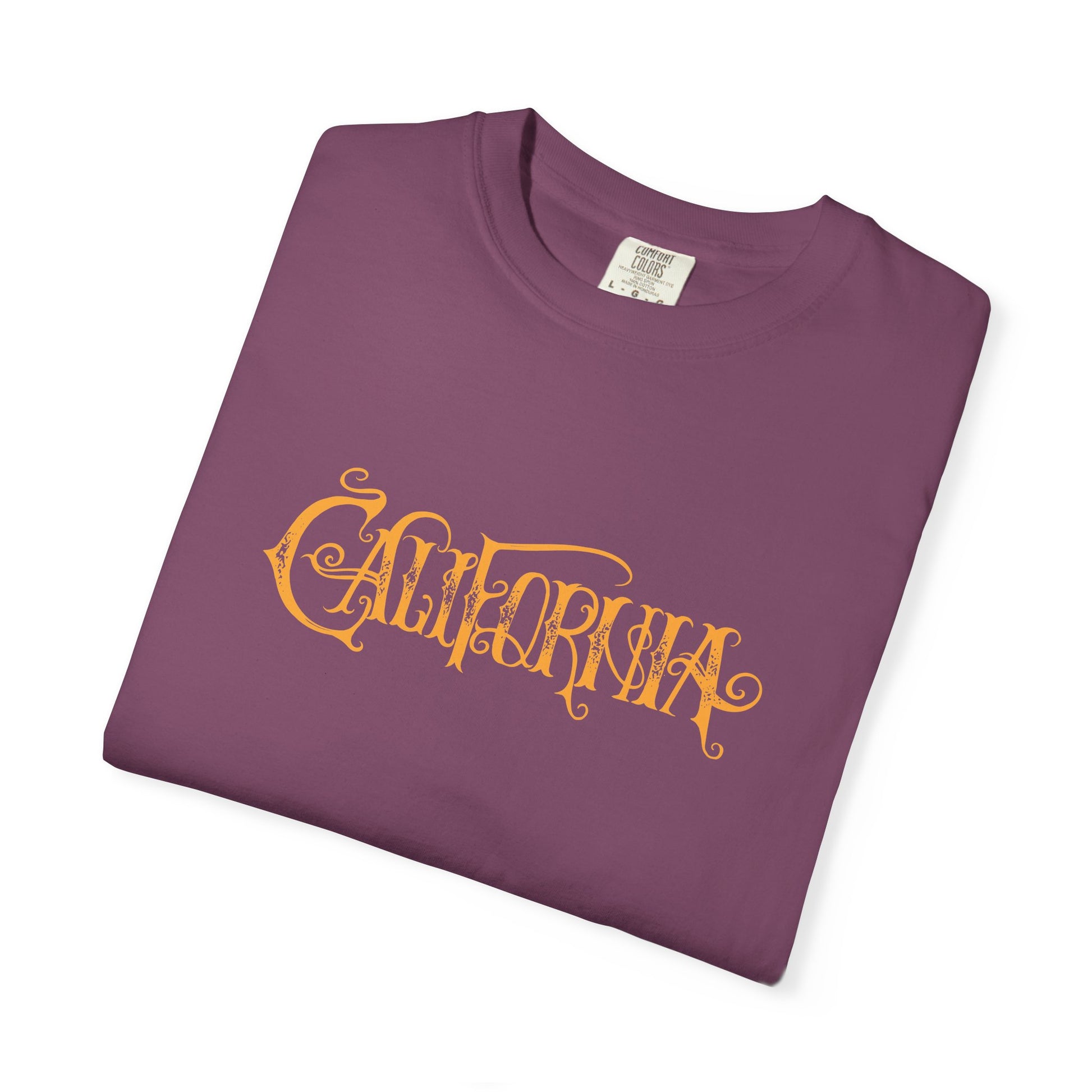 Folded brown t-shirt with pumpkin design and 'Welcome' text on a white background